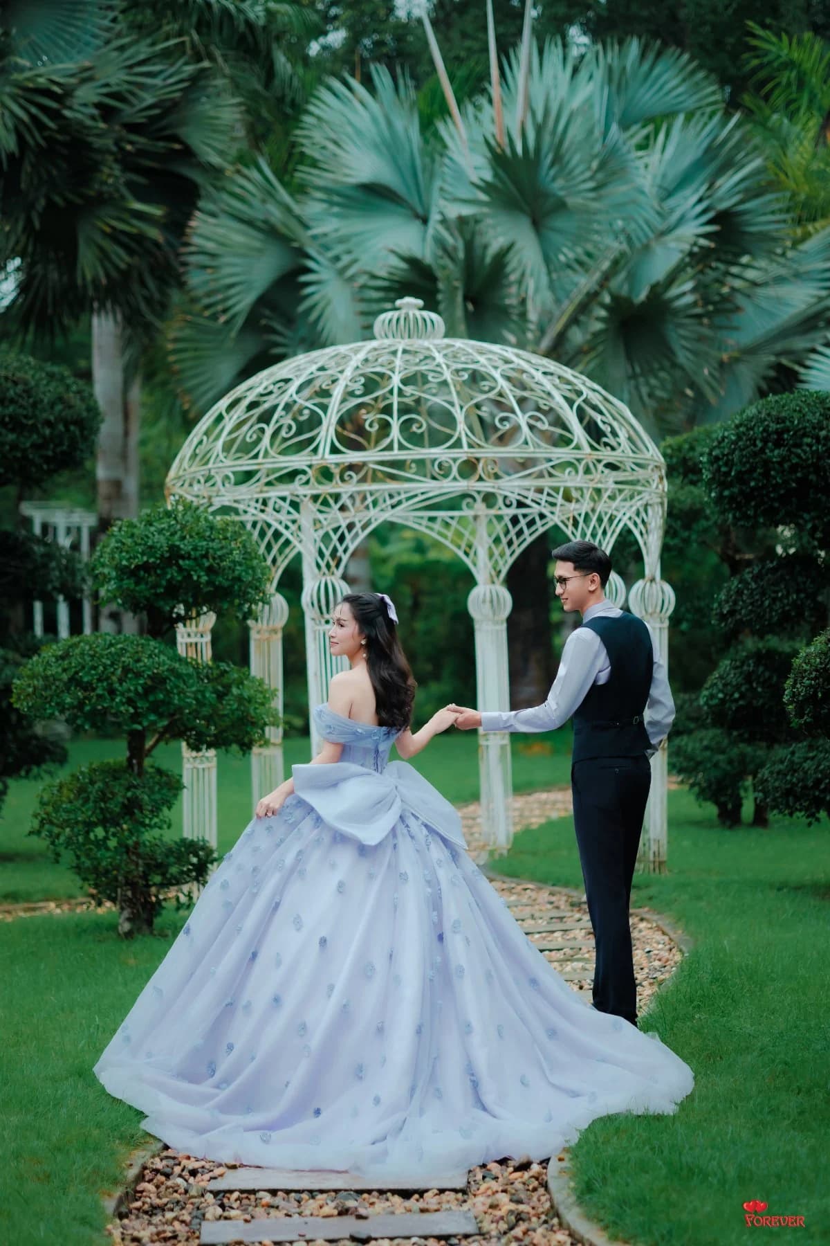 Aung and Hnin by a white garden gazebo