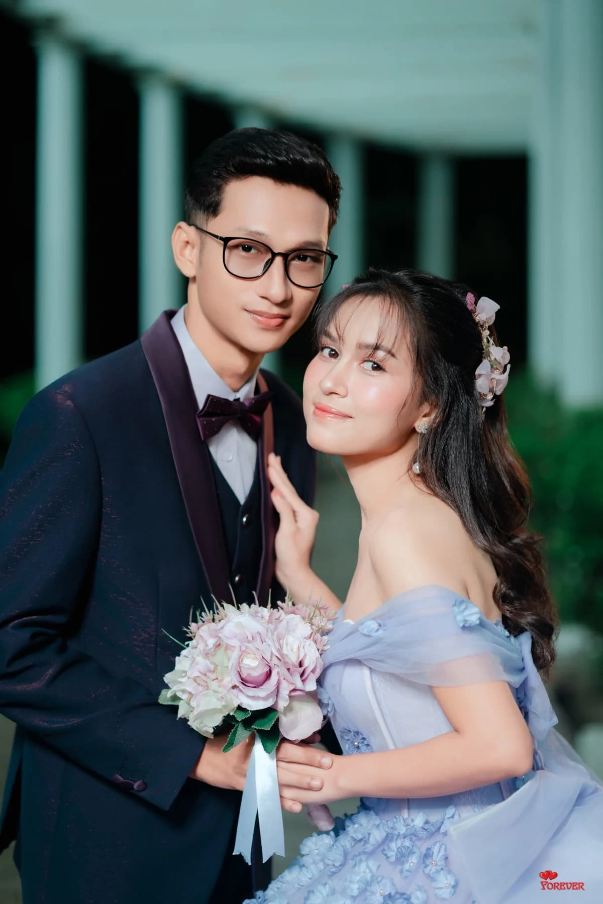 Aung and Hnin cheek to cheek with a lavender bouquet