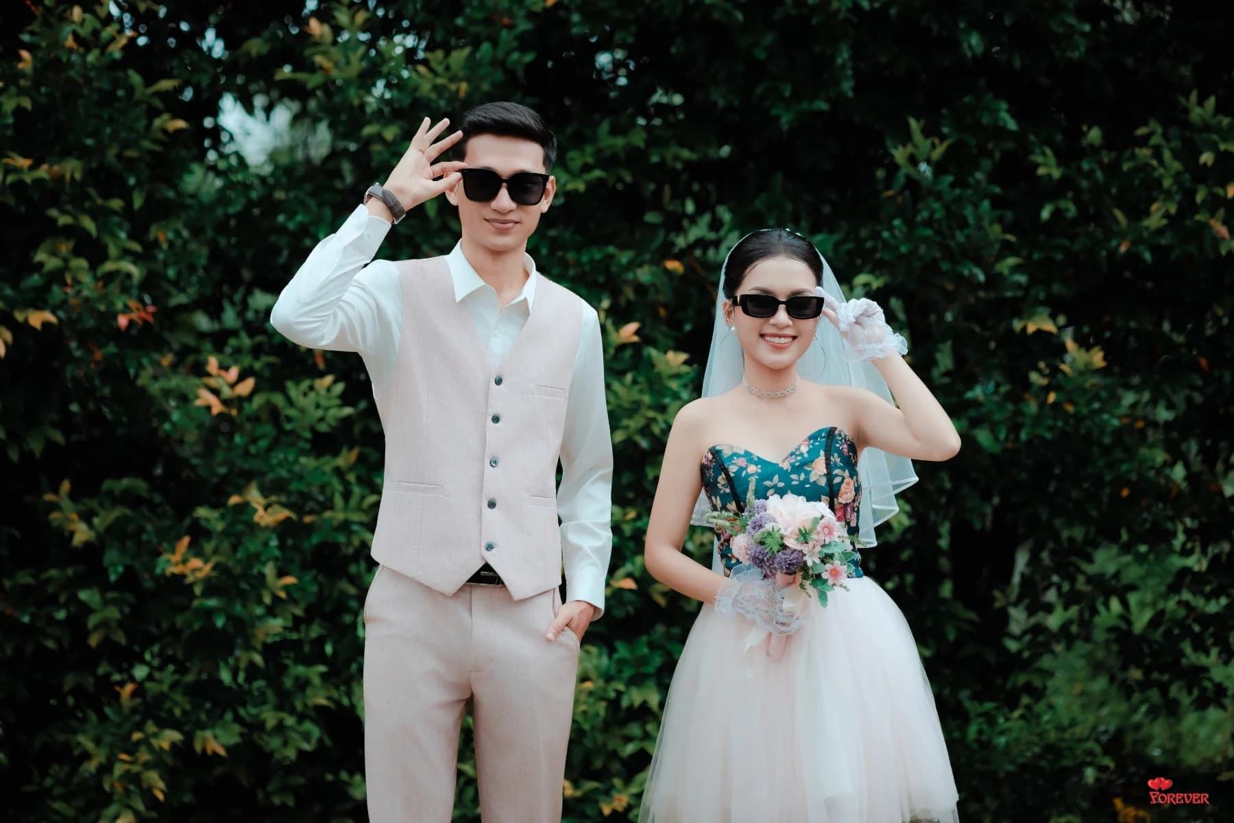 Aung and Hnin in sunglasses in the garden