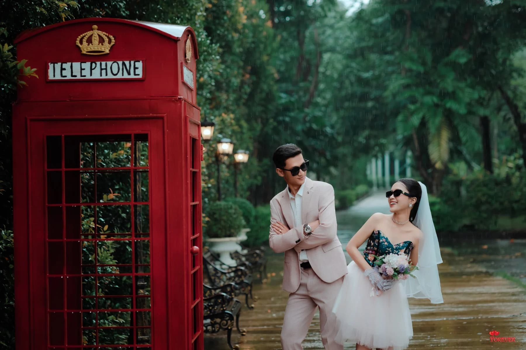 Aung and Hnin by a red telephone box